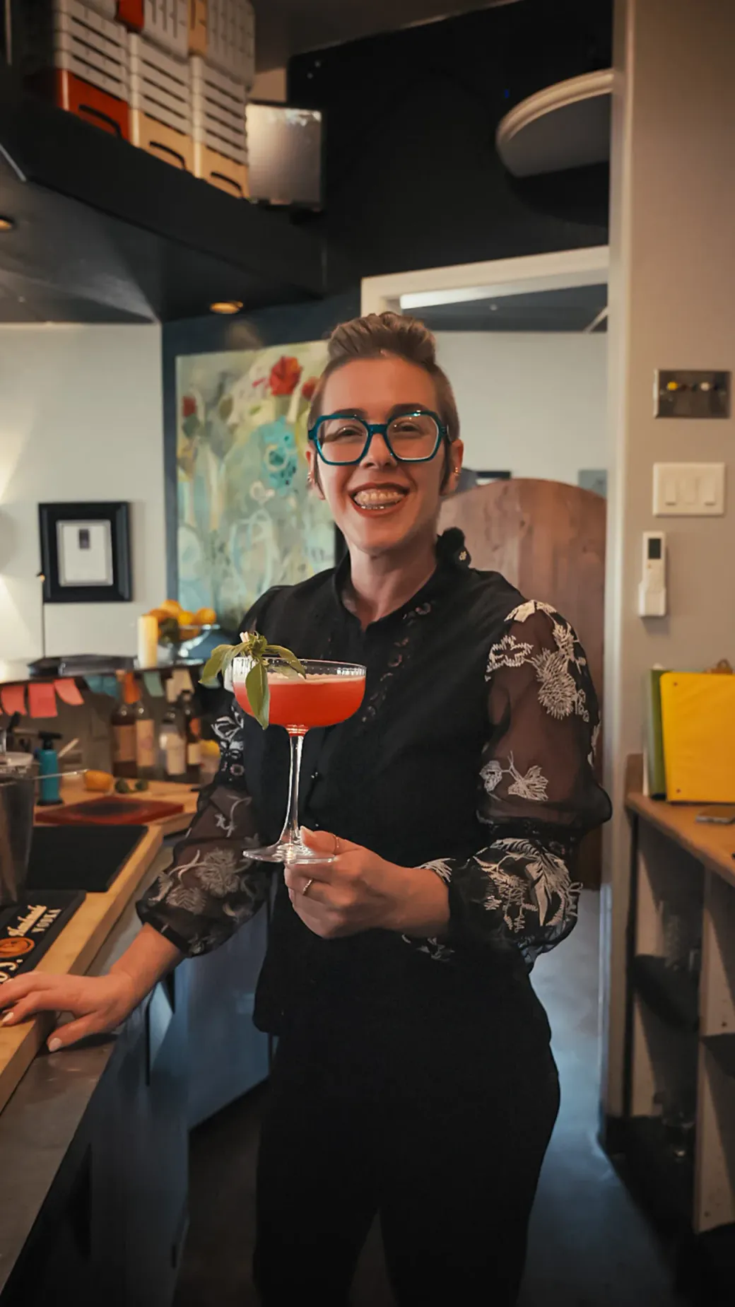 Eli, our bar manager, with a signature cocktail at Aquí
