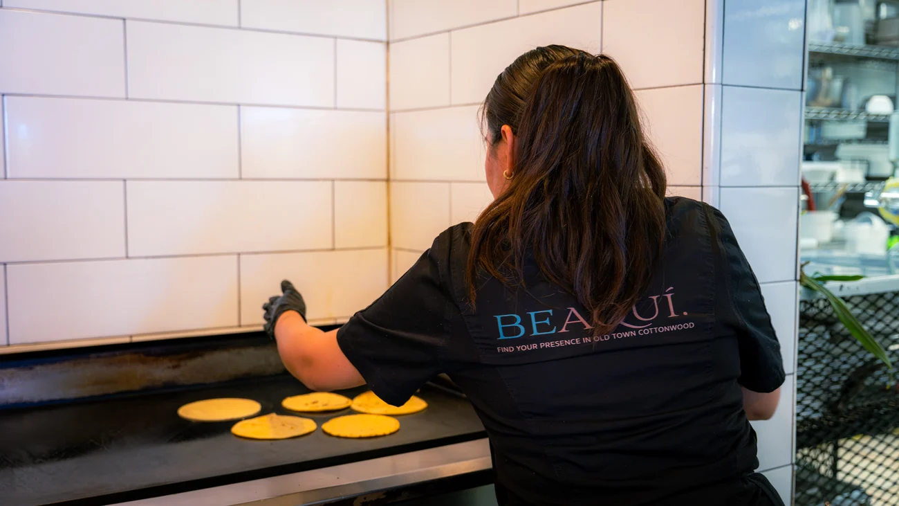 Hand-pressing corn tortillas at Aquí